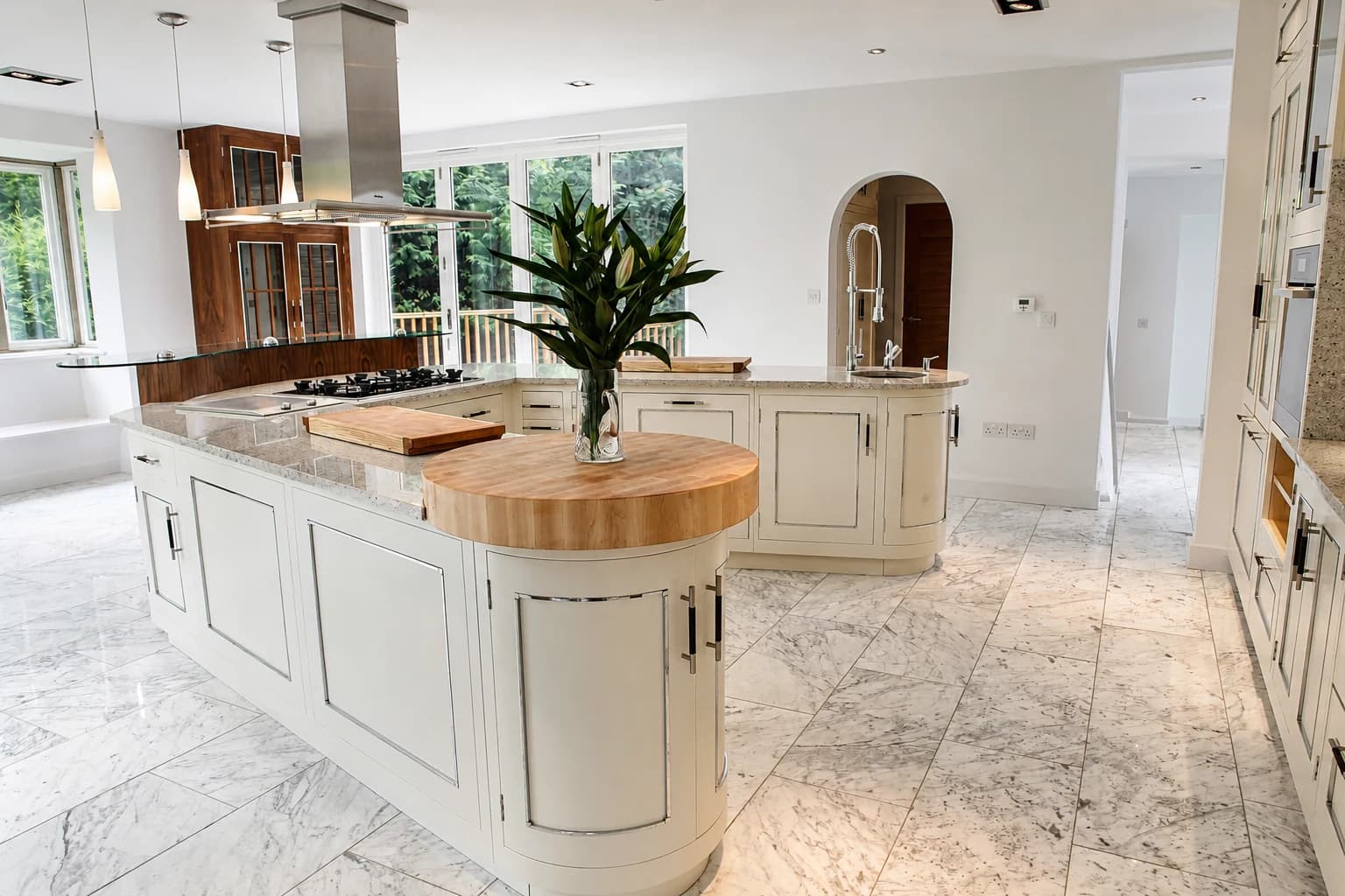 Bespoke fitted kitchen with curved cabinetry and a handmade timber breakfast bar