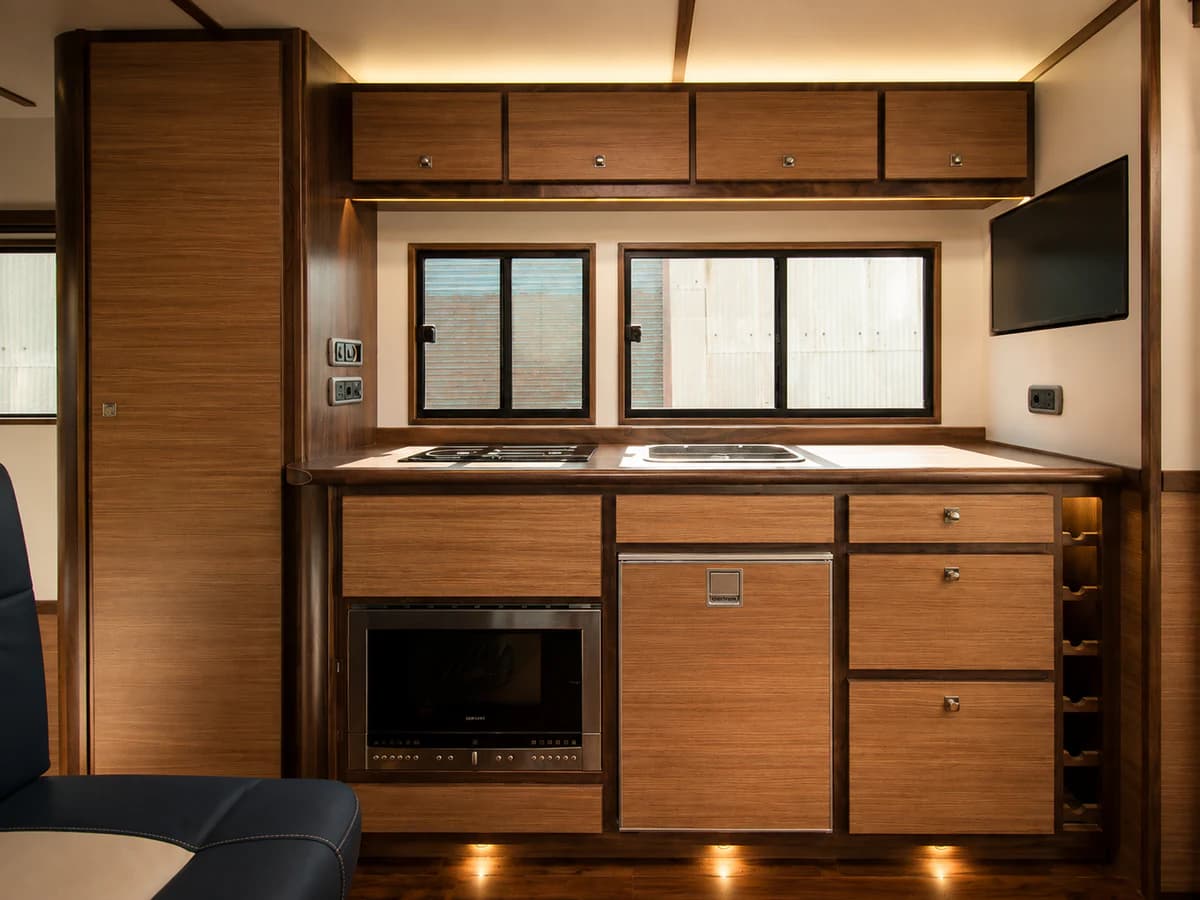 Wide view of the fitted timber kitchenette inside the horsebox