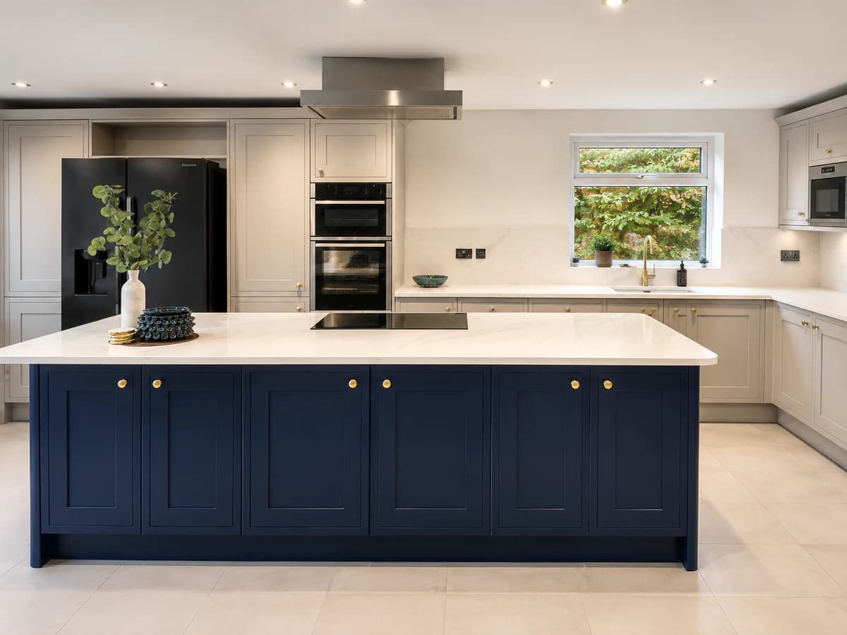 Wide view of the blue island and surrounding neutral kitchen cabinetry