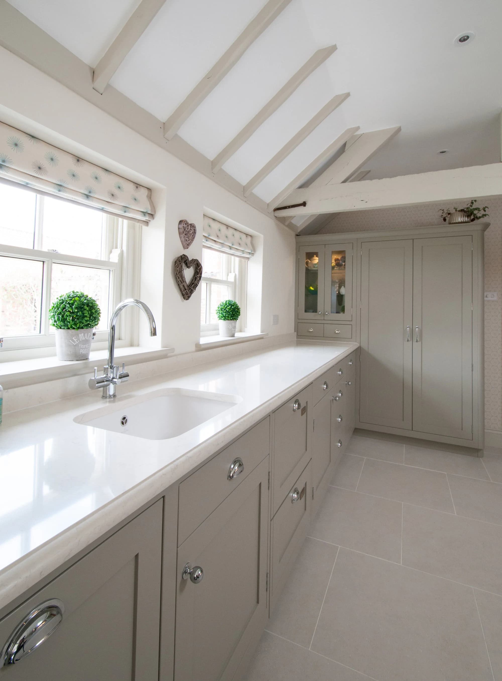 Long sink run beneath cottage windows