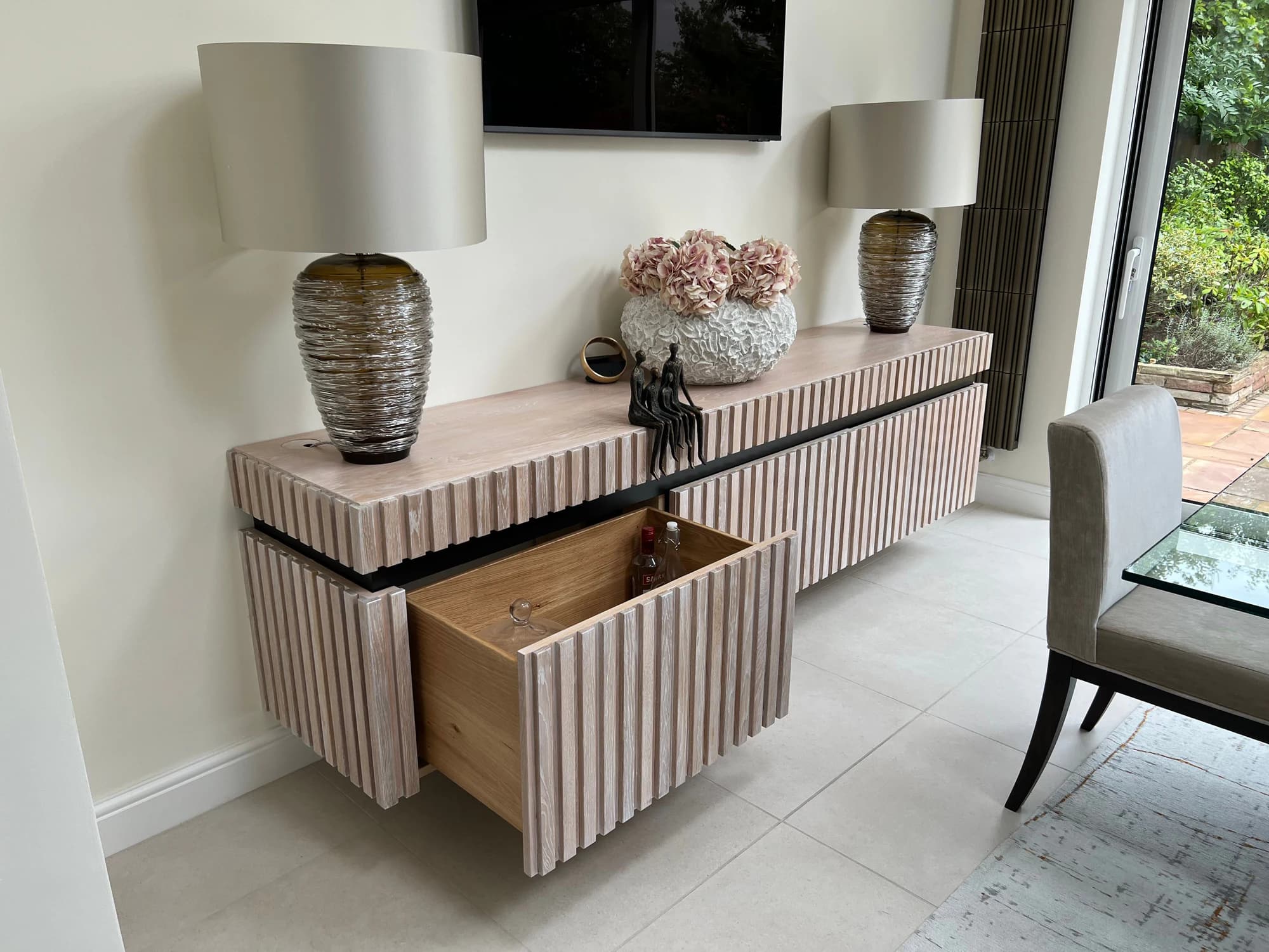 Fluted ash media unit with an open drawer