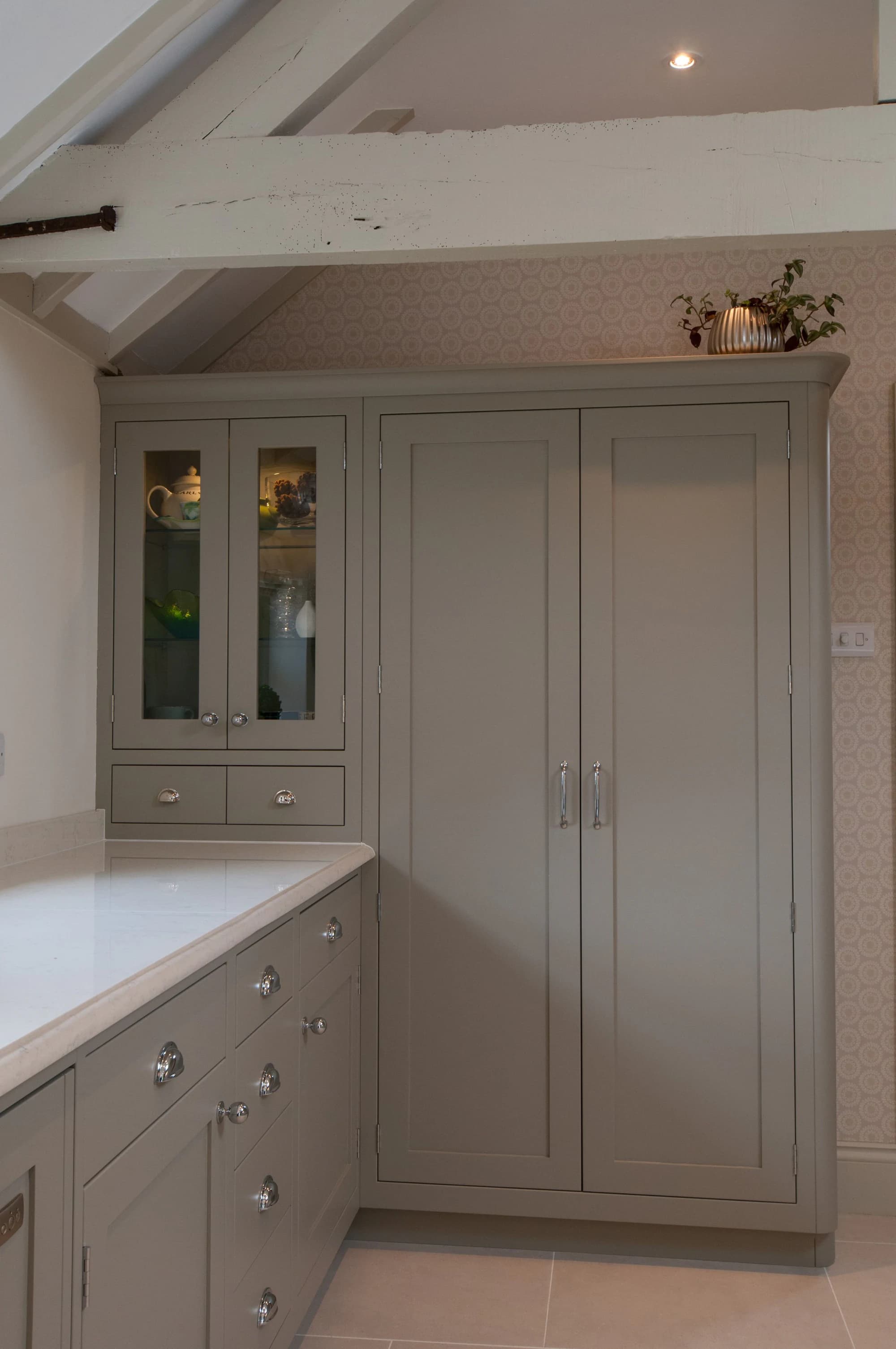 Full-height pantry cabinetry beside the island