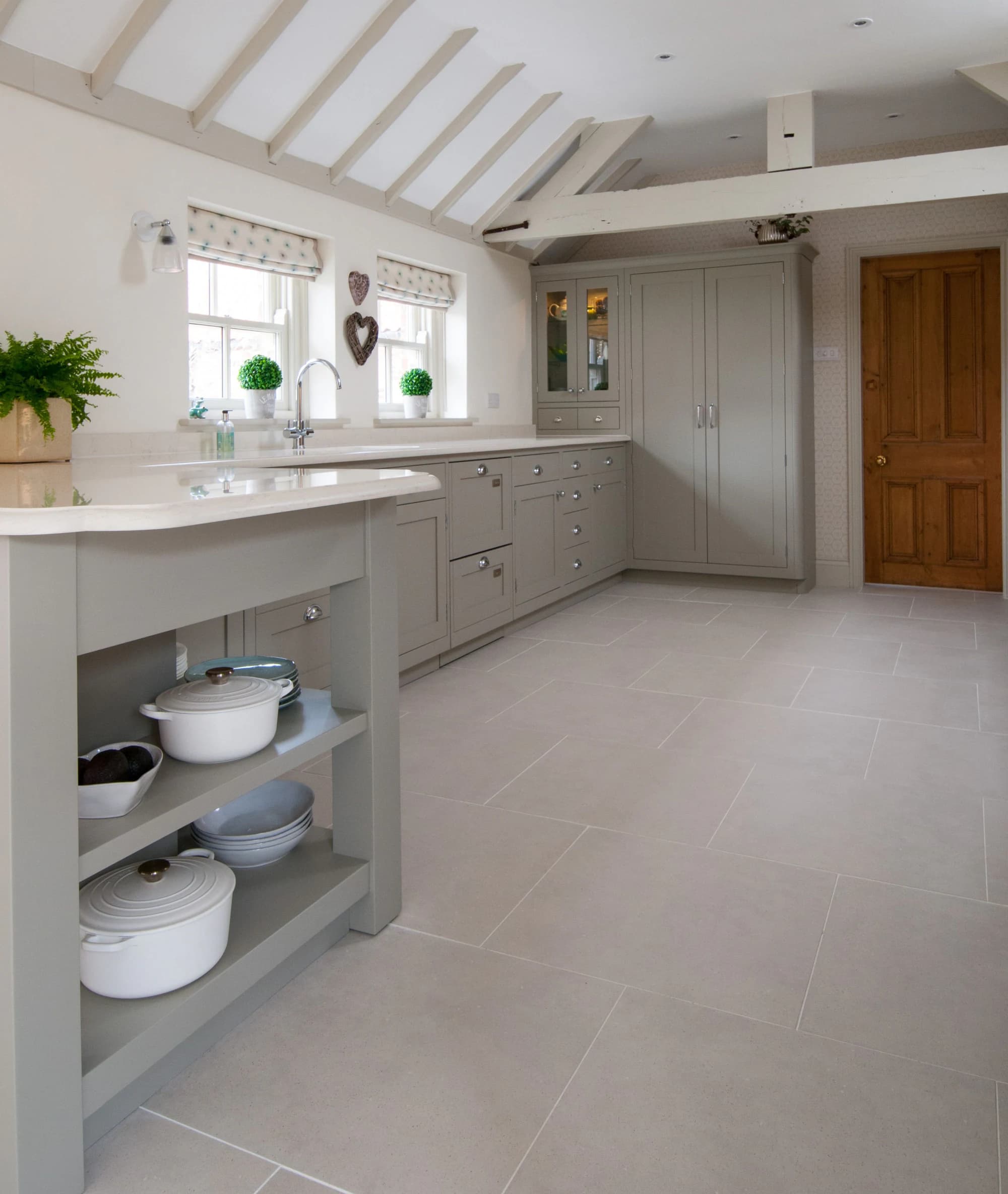 Kitchen island with open shelving and rounded worktop corners