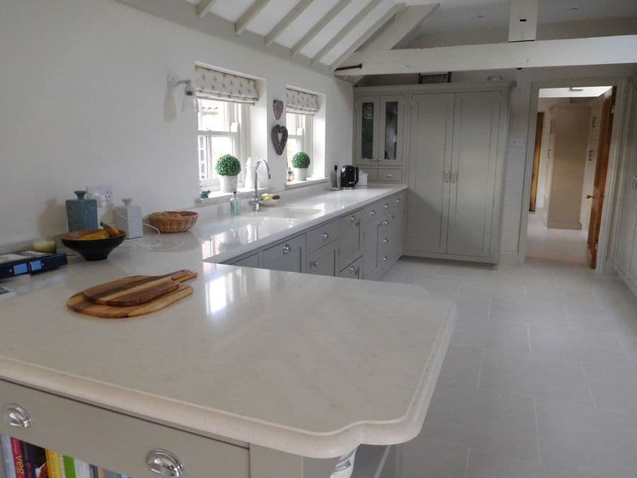 Pale island worktop looking toward the sink and cabinetry