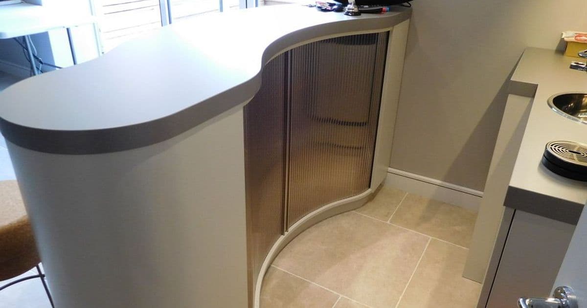 Close view of the curved fitted bar with cupboards and display shelving