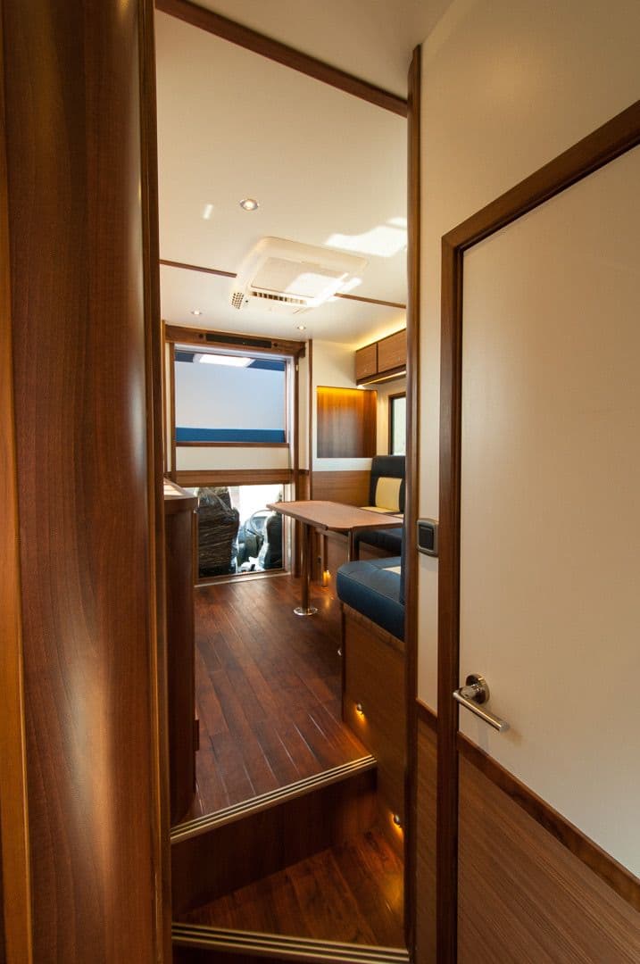 View through the horsebox interior showing coordinated timber doors and storage