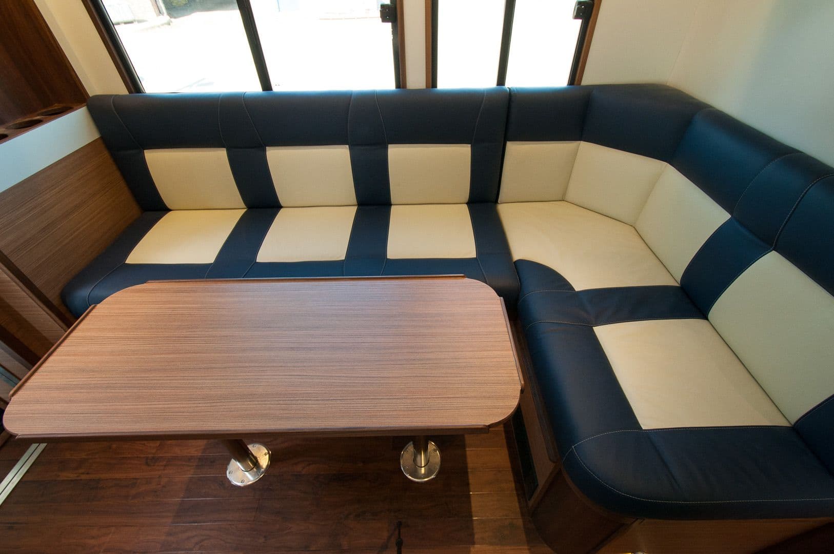 U-shaped upholstered seating and central table in the horsebox living area